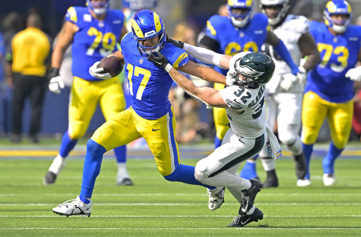 Rams receiver Puka Nacua stiff-arms Eagles safety Reed Blankenship.
